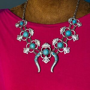 Silver and Turquoise colored Squash blossom necklace.